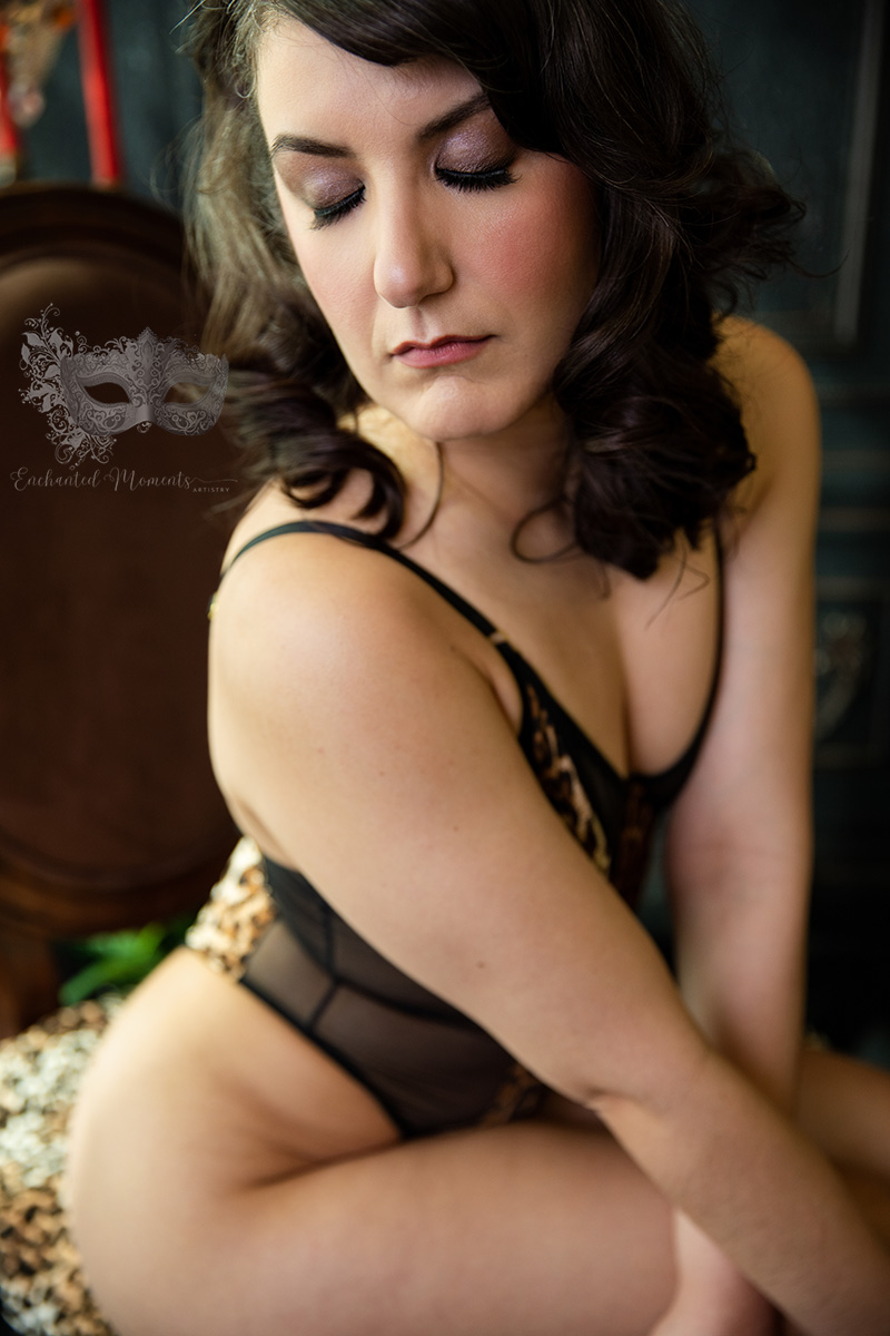 A woman sits with eyes closed on a chair with arms crossed in front of her